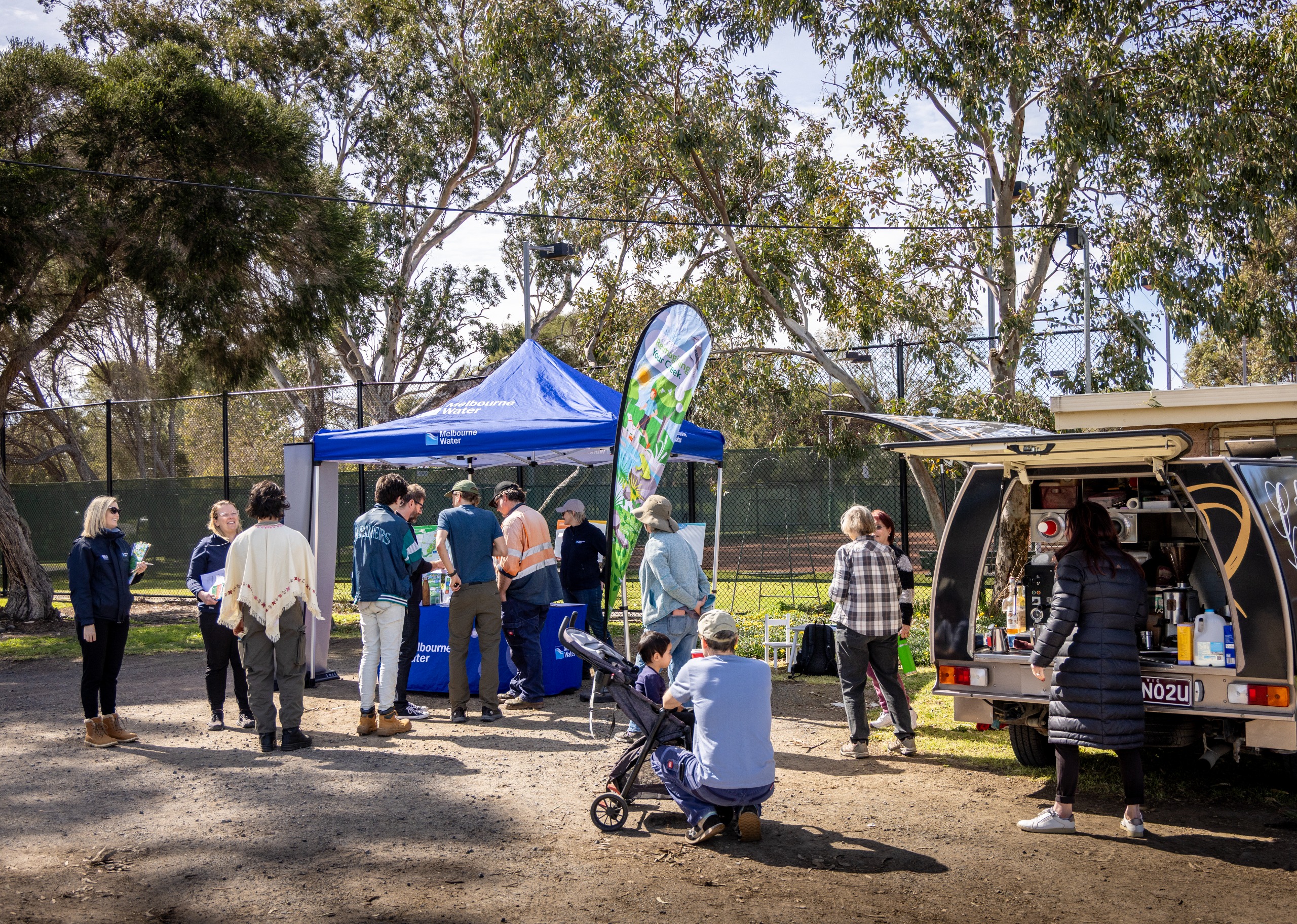 Photo of session with marque, people talking and coffee van