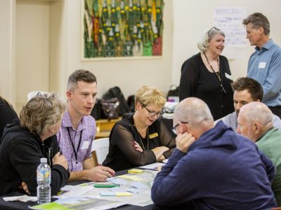 Community Advisory Group members sitting at table and discussing concept design