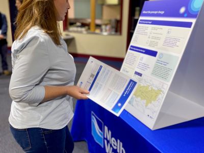 A resident looking at information on a poster.