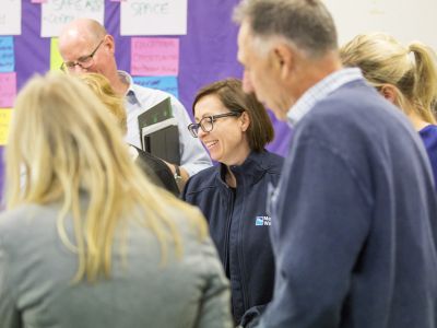 Tarralla Creek Community Advisory Group standing at tables with maps
