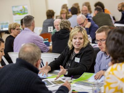Community Advisory Group members sitting at table and discussing concept design