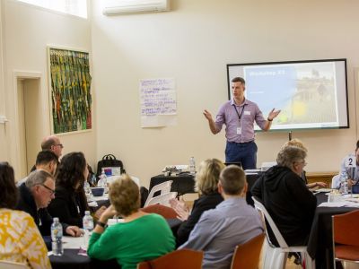 Man summarising concept design to Community Advisory Group members