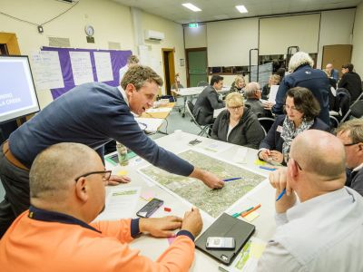 Tarralla Creek Community Advisory Group sitting at tables with maps
